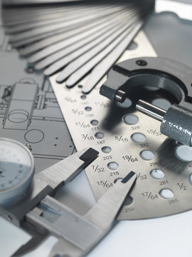 Engineering design -  micrometer, screw gauge and feeler gauge on blueprint