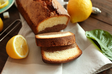 Delicious sweet cake bread with lemons on napkin closeup