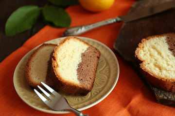 Delicious sweet cake bread in plate on orange napkin closeup