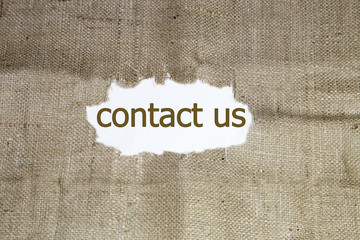 contact us word written under brown torn burlap
