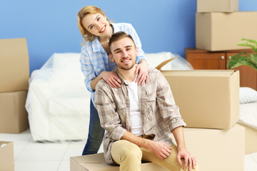 Happy young couple moving in their new apartment