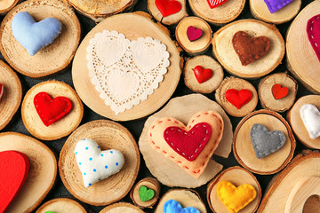 Valentine's Day concept. Different handmade hearts on wooden stumps background