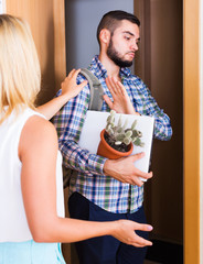 Frustrated couple standing at doorway
