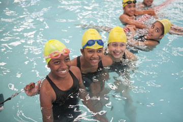 Group of schoolgirls taking a break in swimming pool