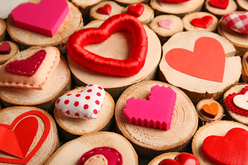 Set of different craft hearts on wooden logs