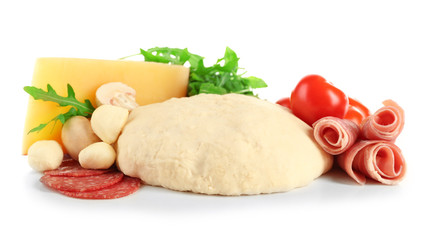 Fresh dough and other different ingredients for pizza isolated on white