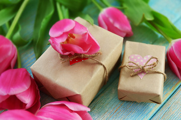 Fresh pink tulips on a wooden table, top view