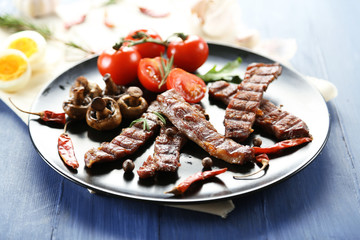 Grilled beef with vegetables on plate