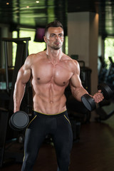 Obraz na płótnie Canvas Young Man Working Out Biceps