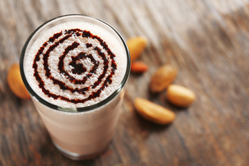 Delicious milk cocktail on rustic background, close up