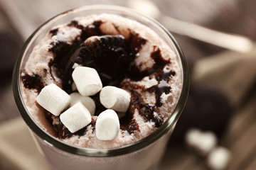 Delicious milk cocktail on rustic background, close up