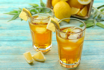 Glasses of ice lemon tea on wooden table
