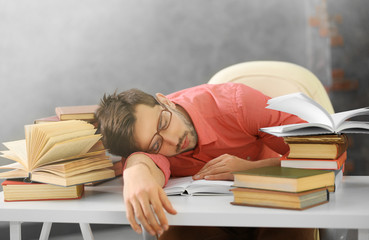 Young man fell asleep during reading.