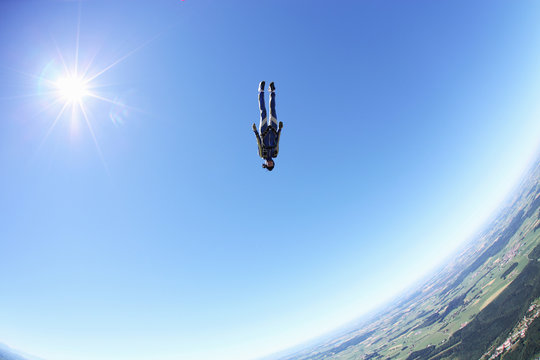 Female skydiver free falling head first above Leutkirch, Bavaria, Germany