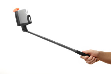 Hand holding stick for making photo with mobile phone, isolated on white