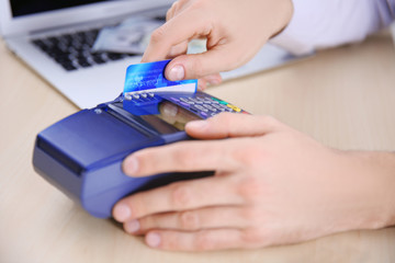 Businessman using payment terminal