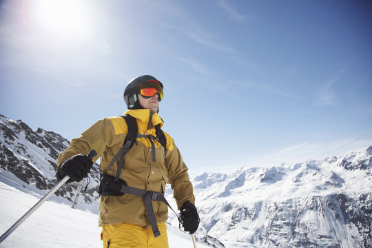 Low angle view of mid adult male skier on mountain, Austria