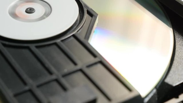 Finishing reading sequence of CD disk in player mechanism 4K 2160p UltraHD footage - DVD disc in players mechanism rotating fast 4K 3840X2160 UHD video 