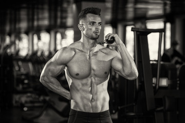 Fototapeta na wymiar Portrait Of A Physically Man With Triceps Rope