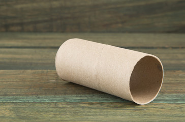 Empty toilet paper roll on the wooden background