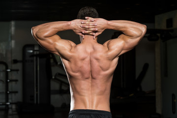 Muscular Men Flexing Muscles In Gym