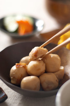Still life of chopsticks picking up japanese dumpling