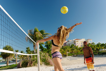 Young adult friends playing beach volleyball, Providenciales, Turks and Caicos Islands, Caribbean