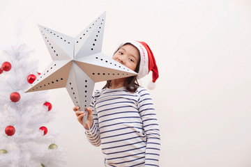 Girl holding up Christmas star, portrait