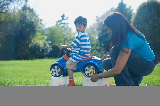 Mother and son pretending to fix toy car
