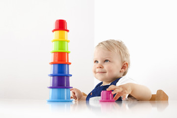 Little boy playing with stacking cups