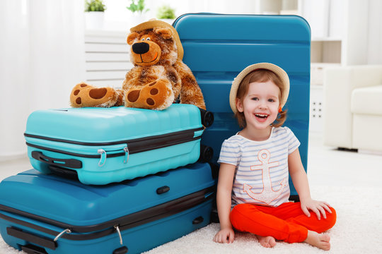 Happy Child Girl Collect Suitcase On Vacation