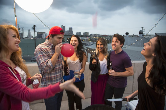 Young adult friends fooling around at barbeque