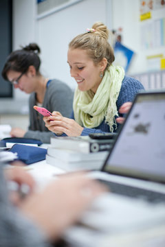 Woman using smartphone in classroom