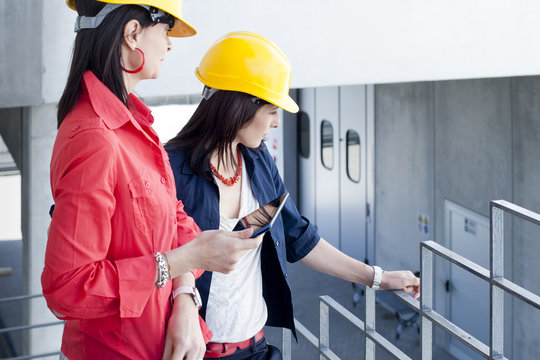 Businesswomen in safety helmet at balcony