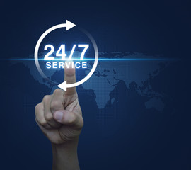 Hand pressing button 24 hours service icon over digital world ma