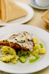 Boiled potatoes and cod in batter