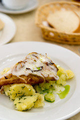 Boiled potatoes and cod in batter