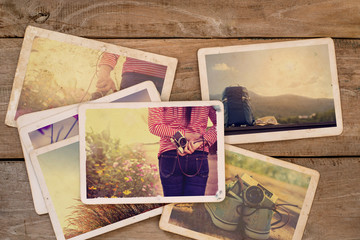 Fototapeta na wymiar Travel photo album on wood table. instant photo of polaroid camera - vintage and retro style