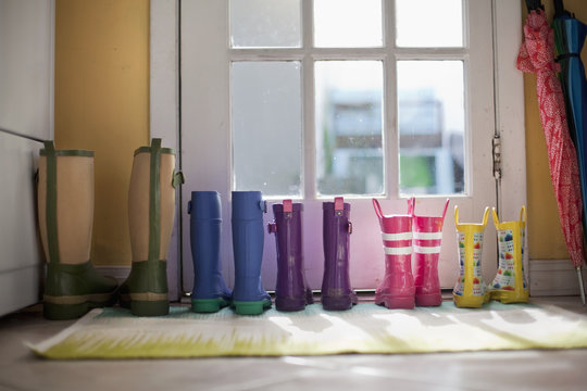 Tidy row of rubber boots at back door