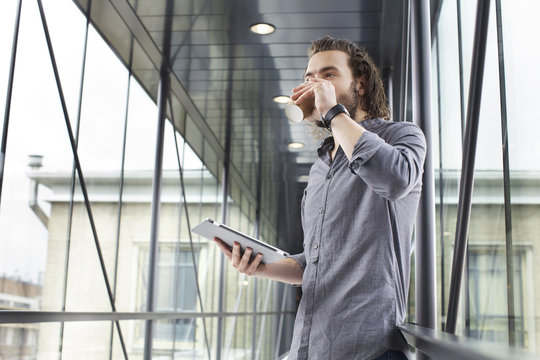 Man With Digital Tablet On Coffee Break