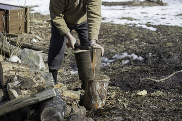 Man with an ax chops firewood