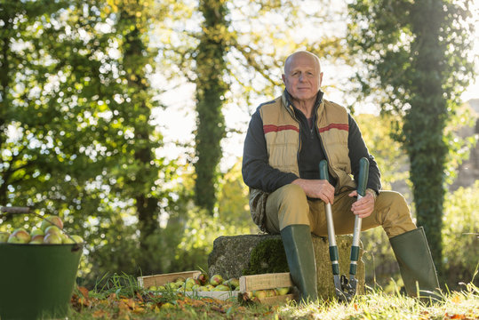 Portrait of senior man holding pruner