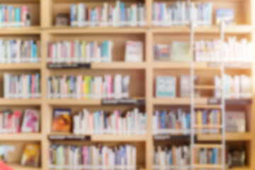 blurred bookshelf in library room for your background design