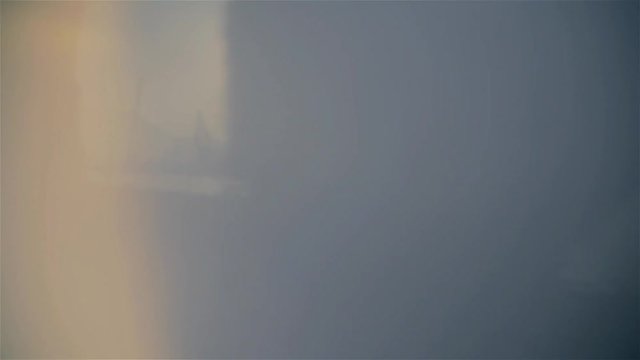 Sun shines through Japanese flag held by pround young Japanese Runner