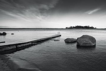 Saimaa lake landscape with pier, monochrome