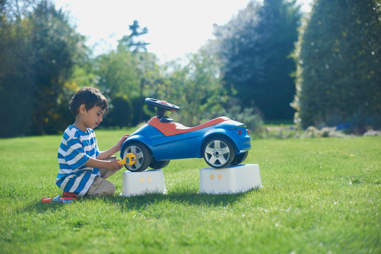 Boy pretending to fix toy car