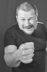 Agressive bully threatens with a fist