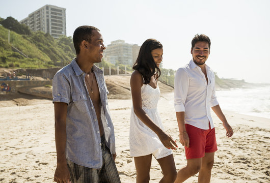 Three friends strolling on Arpoador beach, Rio De Janeiro, Brazil