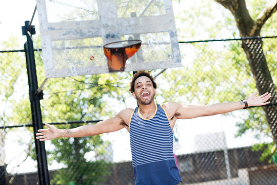 Young man celebrating on basketball court