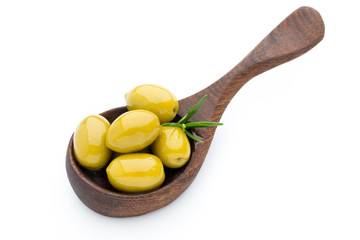 Olives on the spoon leaves isolated on white.
